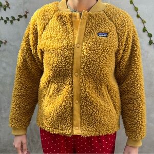 Patagonia kid XL sweater jacket. Color is warm mustard yellow.